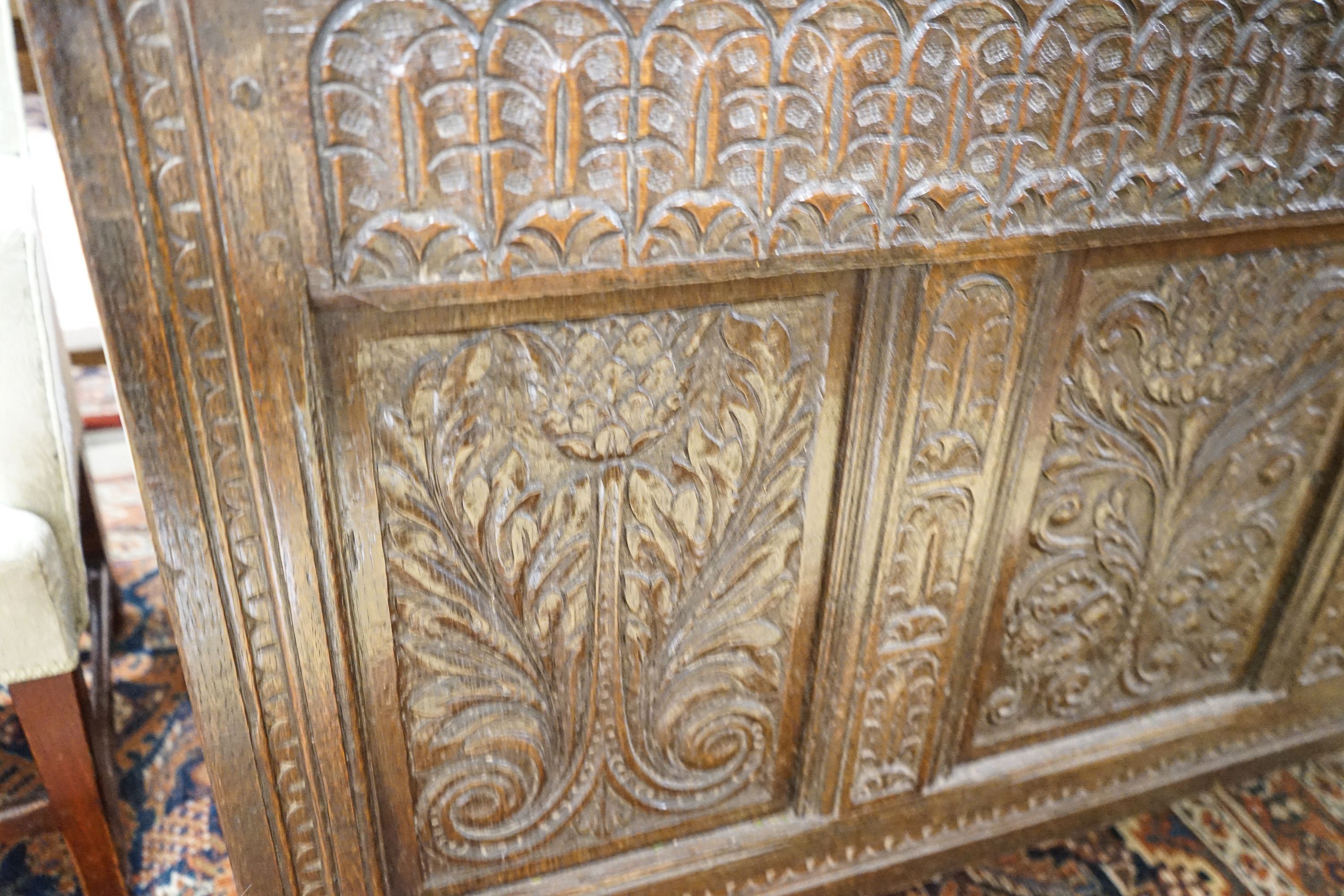 A large 17th century foliate carved oak coffer, length 159cm, depth 72cm, height 76cm